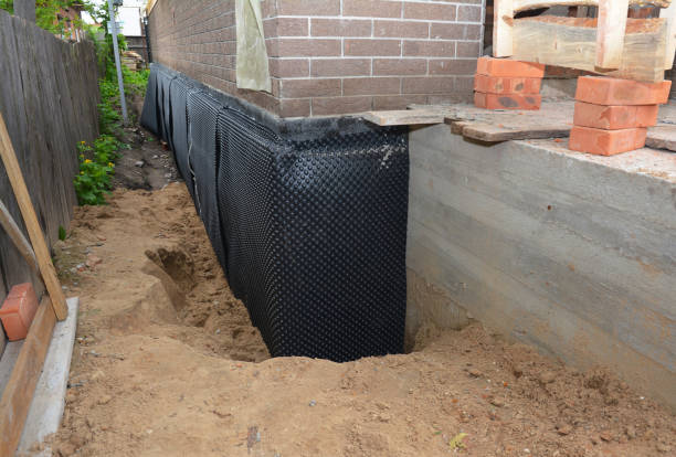 Happy homeowners after waterproofing job in Baxter